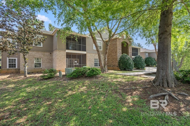 450 Park Ave Unit 112, Foley, AL 36535 - traditional-style home featuring brick siding and a sunroom