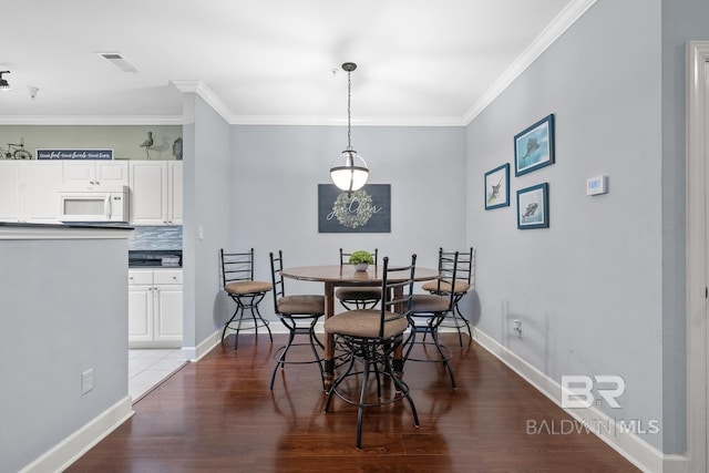 450 Park Ave Unit 112, Foley, AL 36535 - dining area featuring wood finished floors, ornamental molding, and baseboards