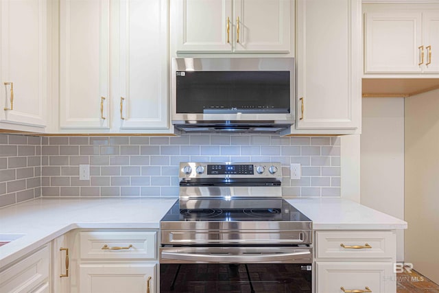 362 Azalea St, Fairhope, AL 36532 - kitchen with stainless steel appliances, white cabinetry, decorative backsplash, and light stone counters