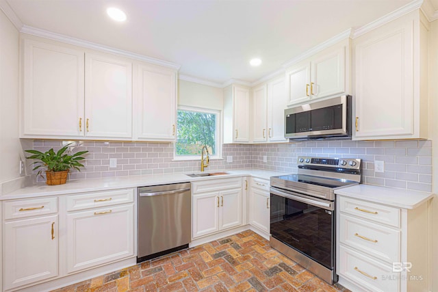 362 Azalea St, Fairhope, AL 36532 - kitchen featuring appliances with stainless steel finishes, a sink, recessed lighting, light countertops, and brick floors