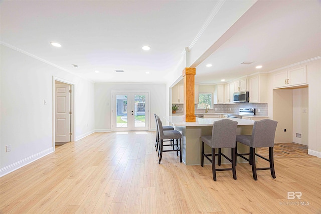 362 Azalea St, Fairhope, AL 36532 - kitchen featuring stainless steel appliances, crown molding, french doors, a breakfast bar, and light countertops