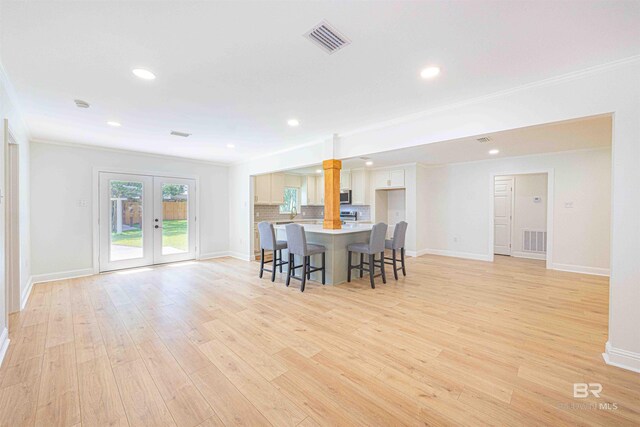 362 Azalea St, Fairhope, AL 36532 - dining space with ornate columns, ornamental molding, light wood finished floors, french doors, and baseboards