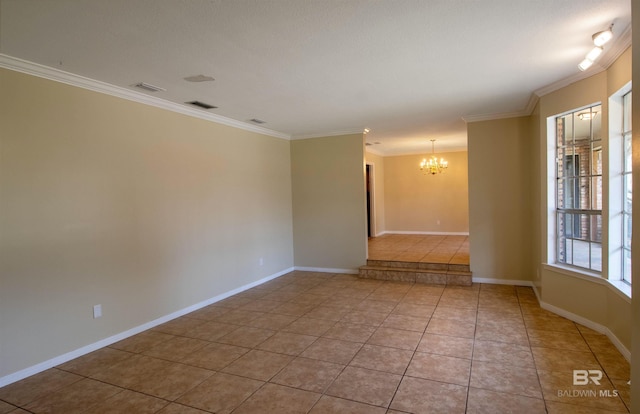 empty room with light tile patterned floors, visible vents, ornamental molding, a chandelier, and baseboards