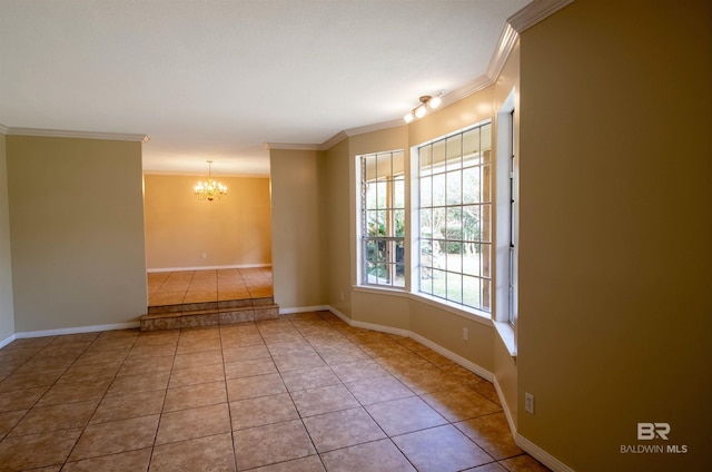 spare room with crown molding, baseboards, a notable chandelier, and tile patterned floors