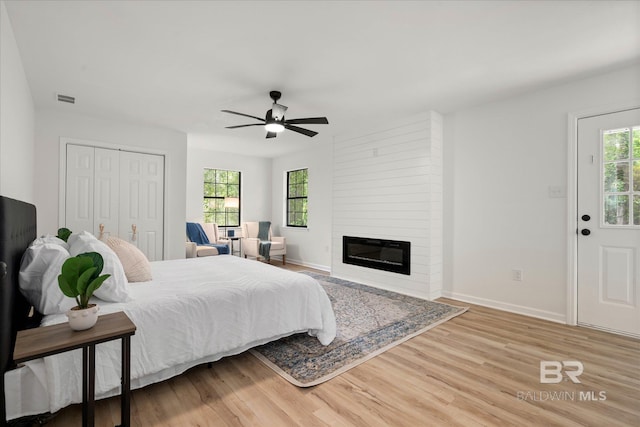 bedroom with visible vents, baseboards, and wood finished floors