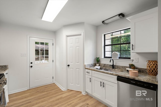 kitchen with a sink, light wood-style floors, white cabinetry, and dishwasher