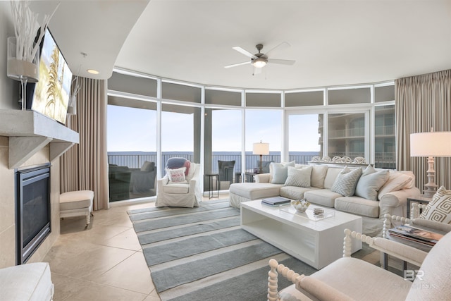 living room featuring ceiling fan and light tile patterned floors