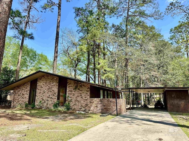 1802 Brookwood Dr, Brewton, AL 36426 - view of side of property with brick siding, driveway, and a carport