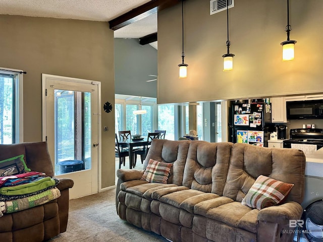 1802 Brookwood Dr, Brewton, AL 36426 - living room featuring light carpet, visible vents, high vaulted ceiling, and beam ceiling