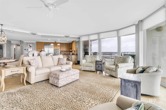 tiled living room with ceiling fan