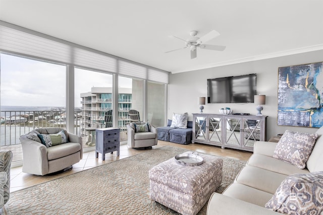 tiled living room featuring ceiling fan and crown molding