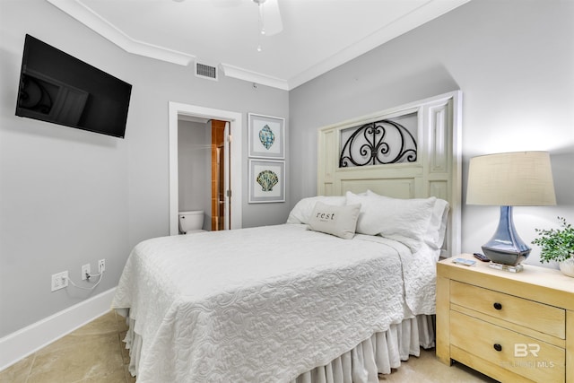 tiled bedroom with ornamental molding, ensuite bathroom, and ceiling fan