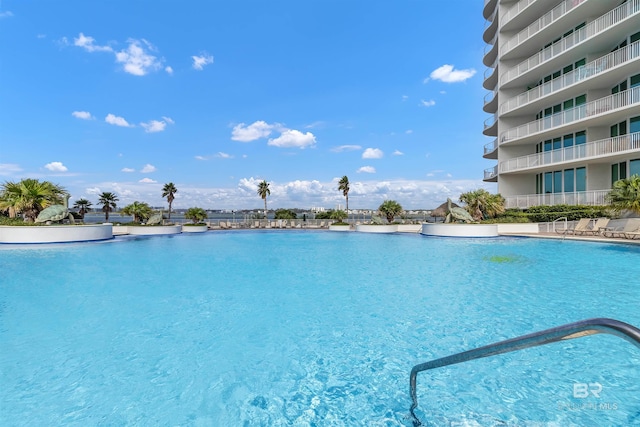 view of swimming pool featuring a water view