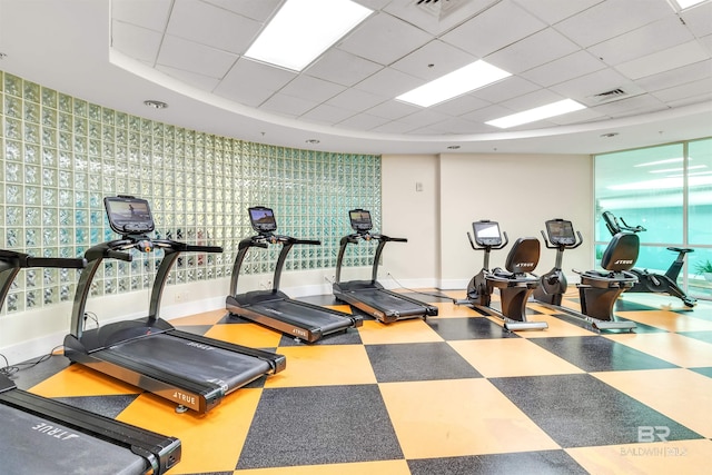 gym with a paneled ceiling