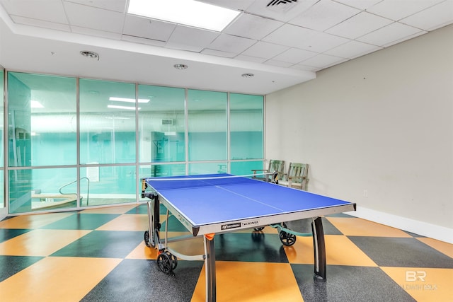 playroom with a paneled ceiling