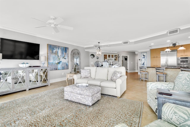 tiled living room with crown molding and ceiling fan