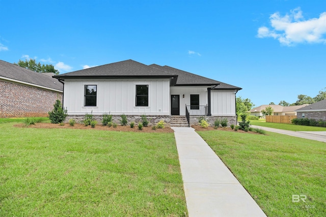 modern inspired farmhouse with a front lawn and a porch