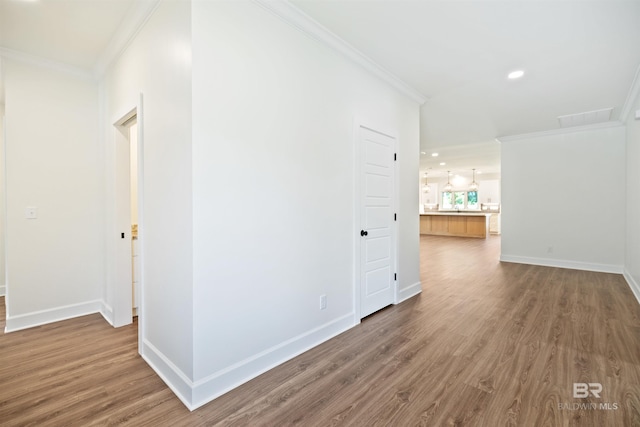 hall featuring wood-type flooring and ornamental molding