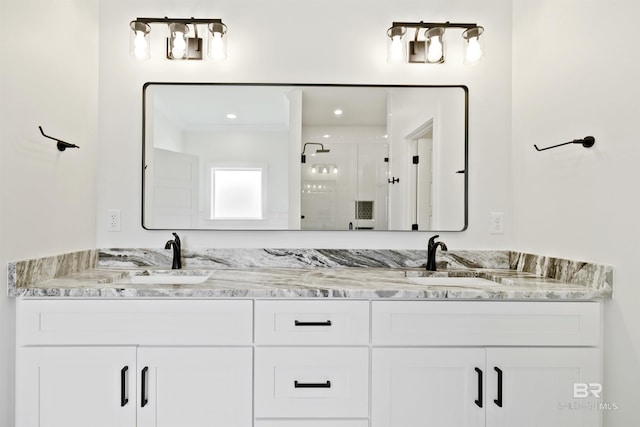 bathroom featuring vanity and a shower with door