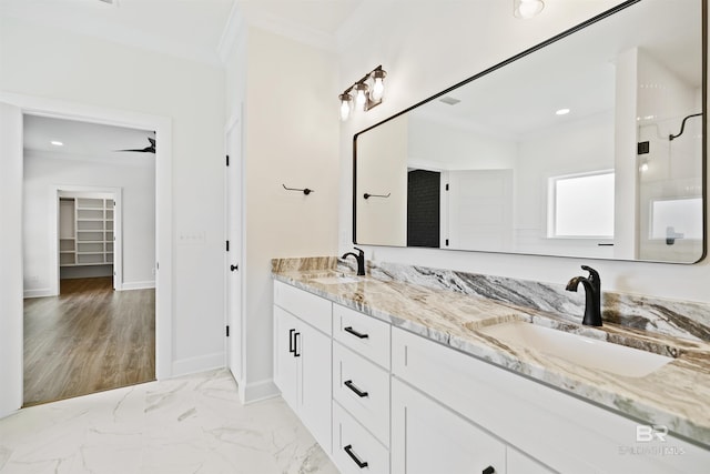 bathroom featuring ornamental molding and vanity