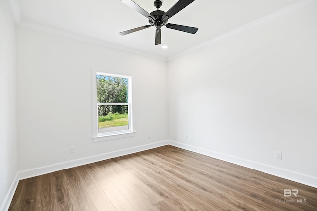 empty room featuring ceiling fan, wood-type flooring, and ornamental molding