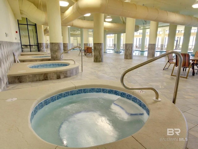 view of pool with an indoor hot tub