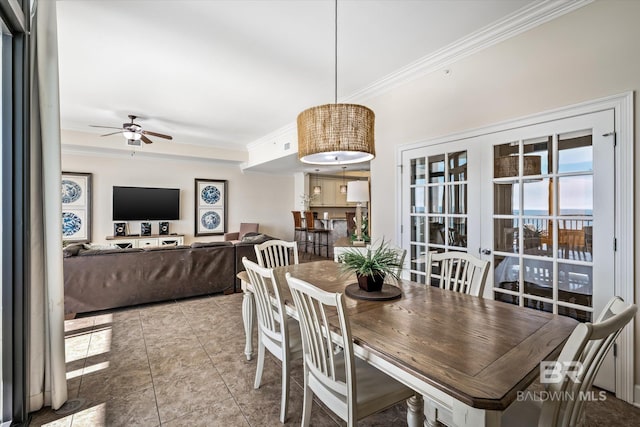 dining space with tile patterned floors, ornamental molding, and ceiling fan