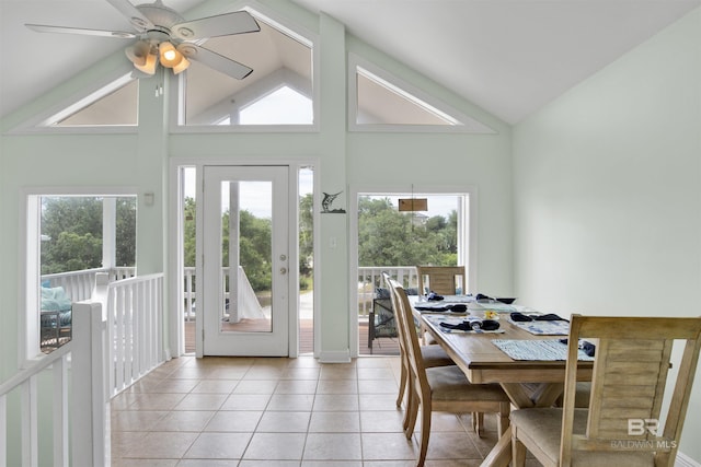 dining space with high vaulted ceiling, light tile patterned floors, and ceiling fan