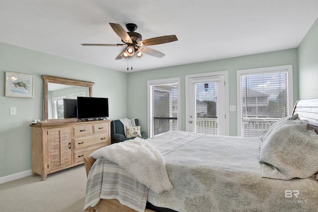 bedroom featuring ceiling fan, baseboards, light carpet, and access to exterior