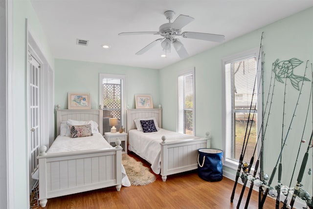 bedroom featuring multiple windows, ceiling fan, and light hardwood / wood-style floors