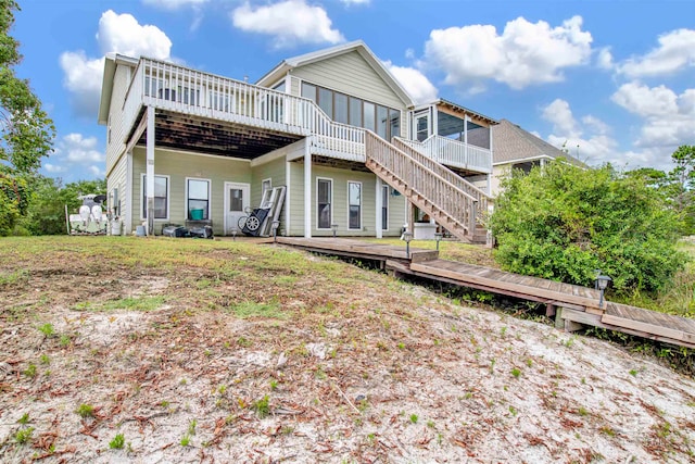 back of house featuring a wooden deck