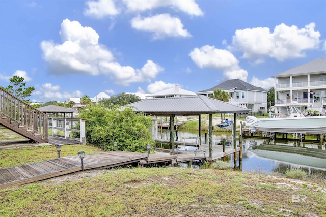 view of dock featuring boat lift, a residential view, and a water view