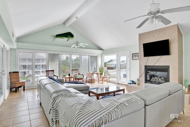 living room featuring beamed ceiling, light tile patterned floors, a tile fireplace, high vaulted ceiling, and ceiling fan