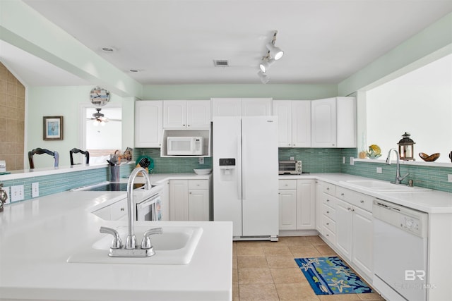 kitchen featuring ceiling fan, white cabinets, white appliances, sink, and backsplash