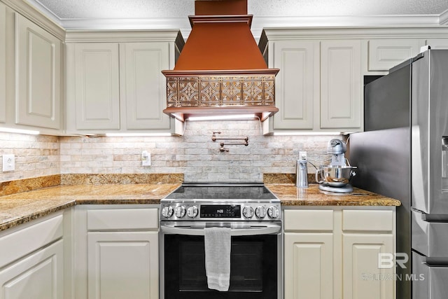 kitchen with premium range hood, appliances with stainless steel finishes, light stone countertops, and decorative backsplash