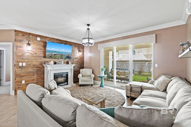 tiled living room with a chandelier, crown molding, wood walls, and a textured ceiling