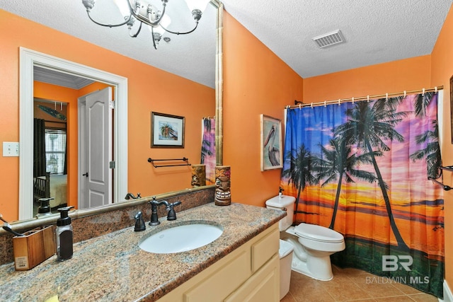 bathroom with tile patterned flooring, toilet, a shower with curtain, a textured ceiling, and vanity