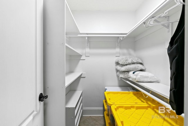 spacious closet with tile patterned flooring