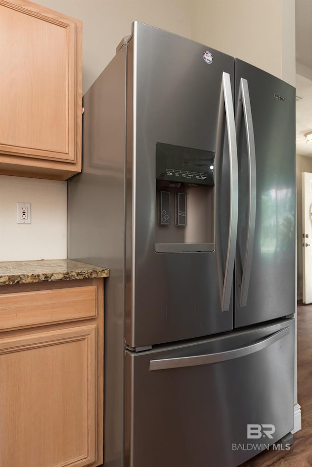 kitchen with stainless steel fridge with ice dispenser, wood finished floors, light stone counters, and light brown cabinets