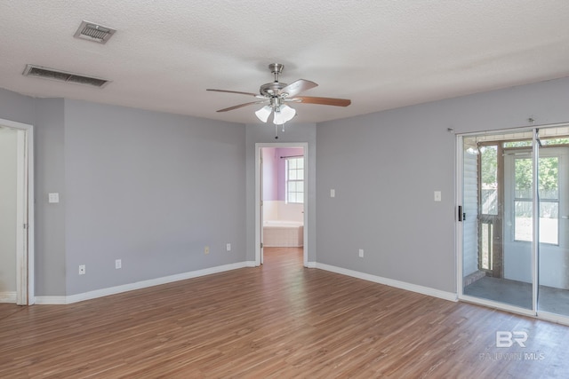 unfurnished room featuring light wood-style floors, baseboards, and visible vents