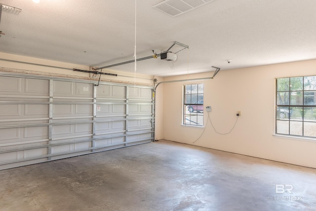 garage featuring visible vents and a garage door opener