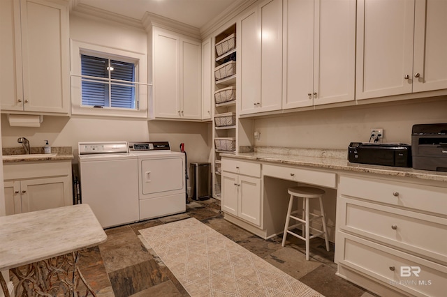 laundry room with laundry area, stone finish flooring, independent washer and dryer, and a sink