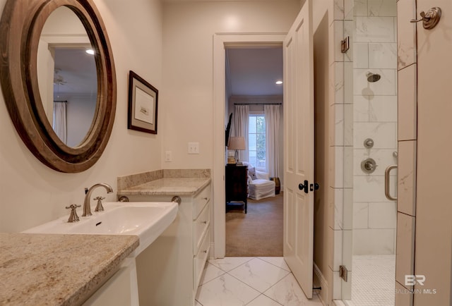 bathroom with marble finish floor, a stall shower, and vanity