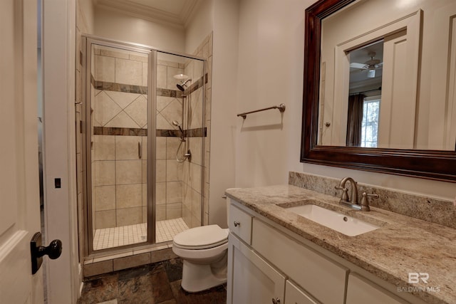 full bathroom with vanity, toilet, a shower stall, and crown molding