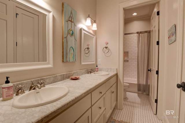 full bathroom with double vanity, toilet, shower / tub combo with curtain, and a sink