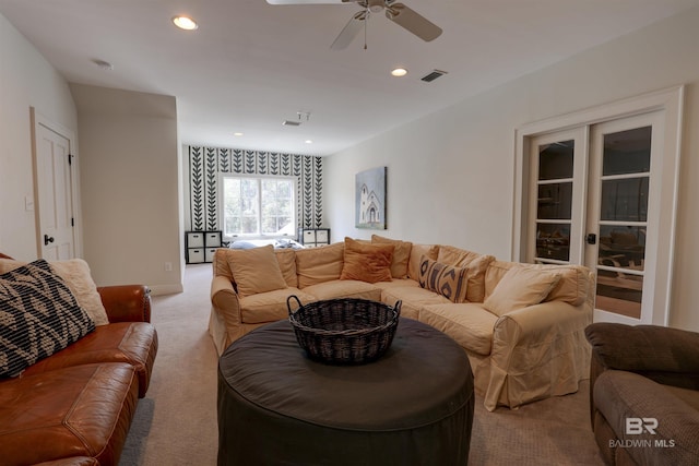 living room featuring light carpet, visible vents, recessed lighting, and a ceiling fan