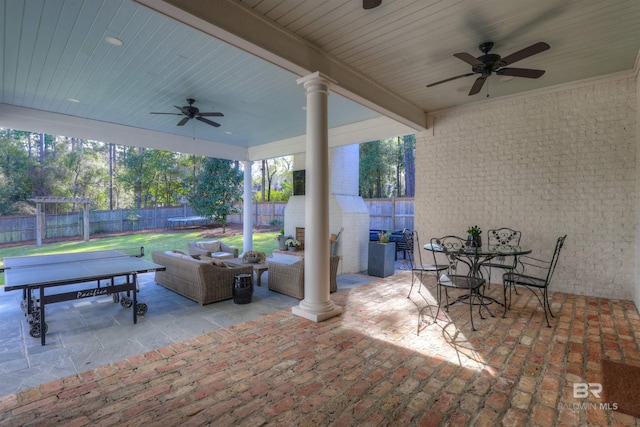 view of patio / terrace with outdoor dining space, a fenced backyard, ceiling fan, a trampoline, and an outdoor hangout area