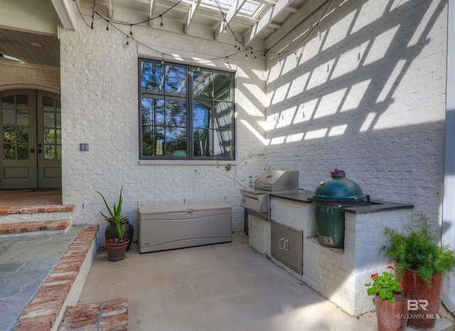 view of patio featuring area for grilling, a grill, and french doors