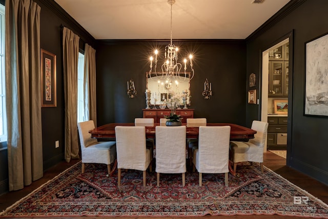 dining room featuring baseboards, crown molding, and an inviting chandelier