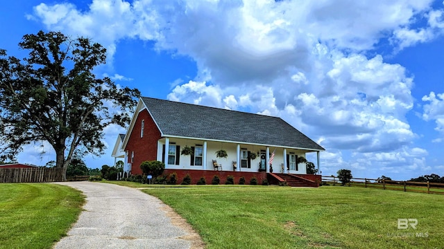 view of front of home with a porch and a front lawn